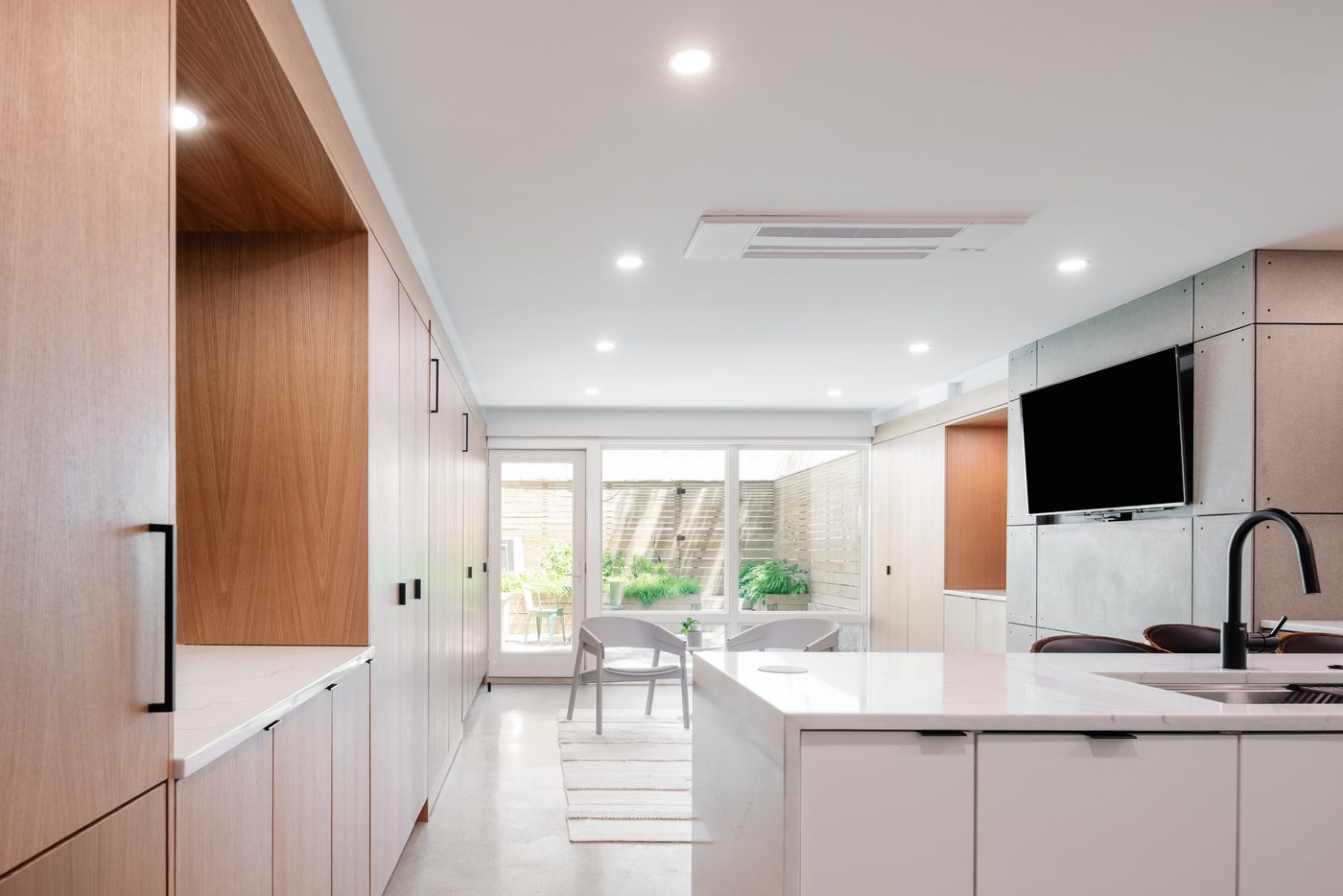 Bright basement guest suite kitchen open to courtyard